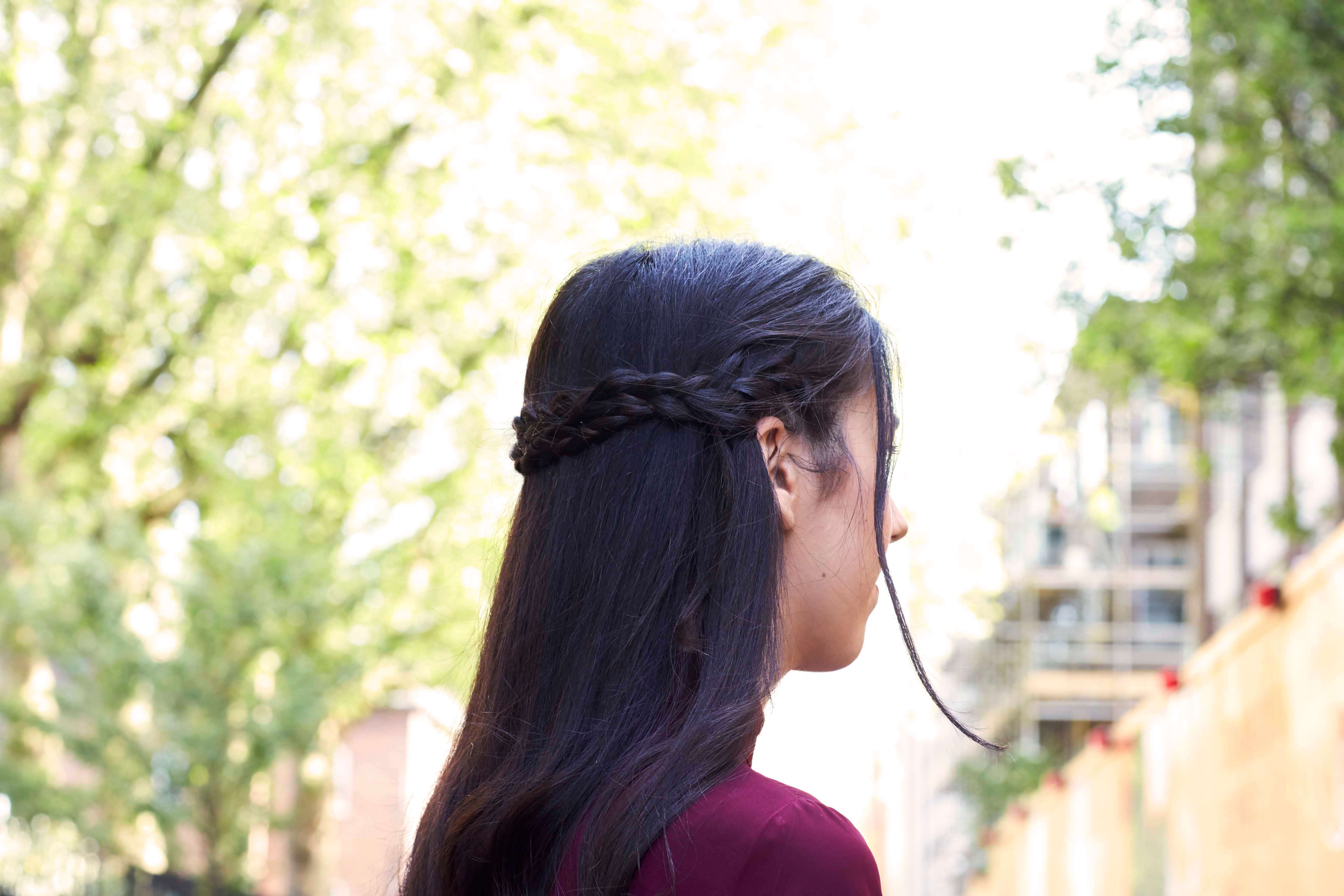 long dark haired model with a half-up, half-down hairstyle braided crown