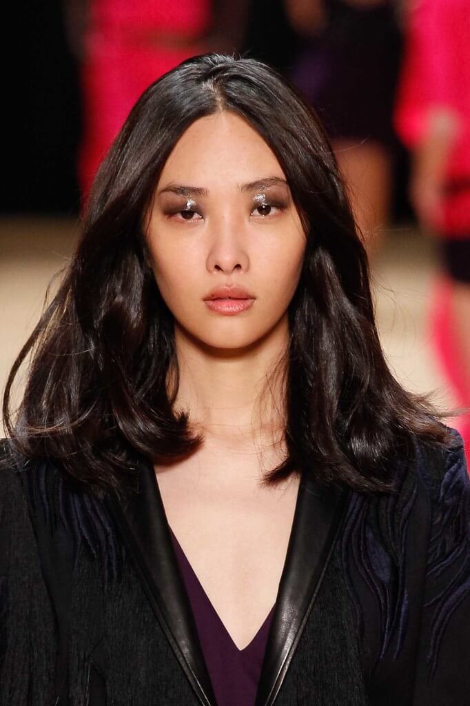 Asian woman with a voluminous blow out long bob hairstyle for round faces