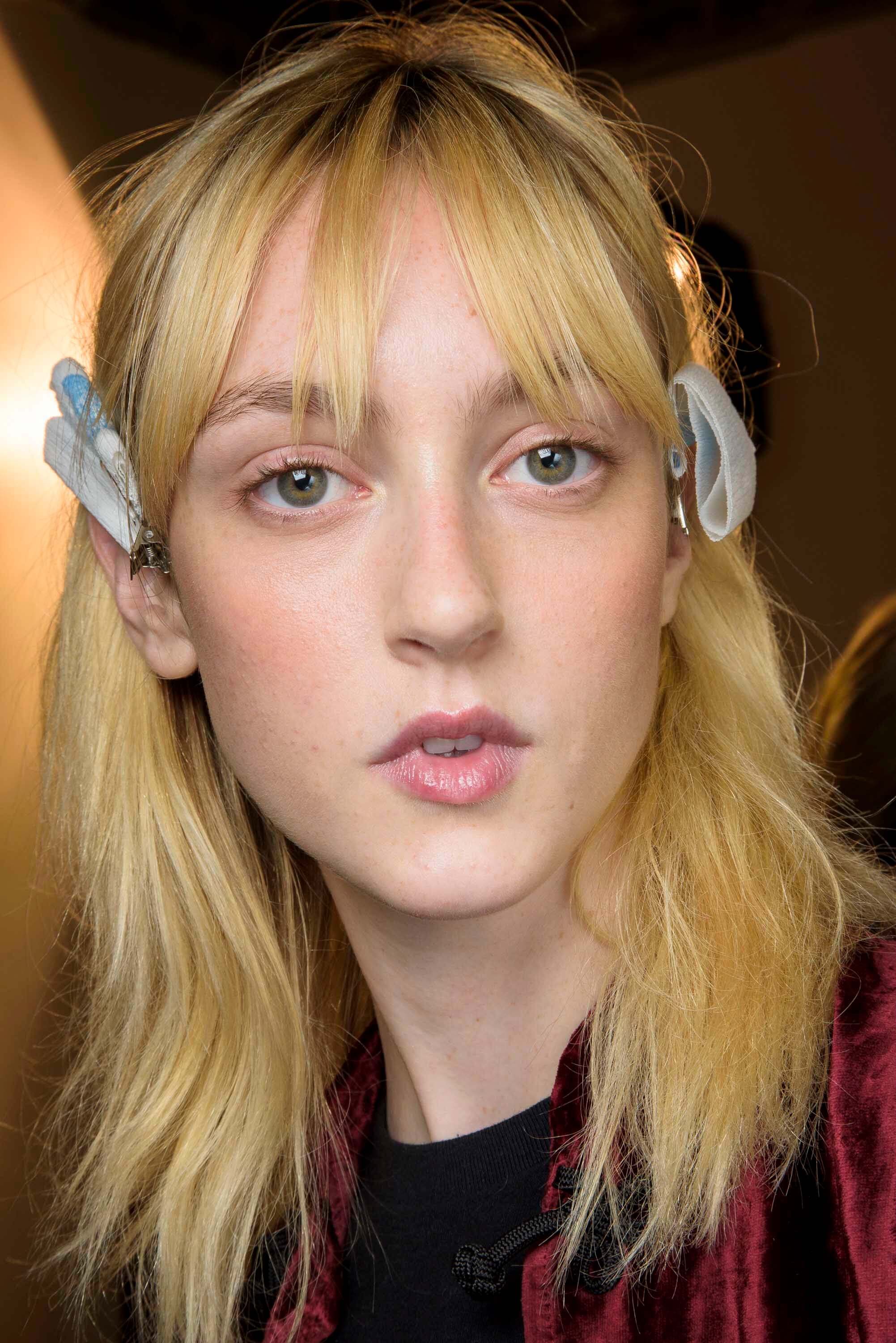 Blonde hair: Front facing image of a woman with long blonde hair in a melted butter shade.