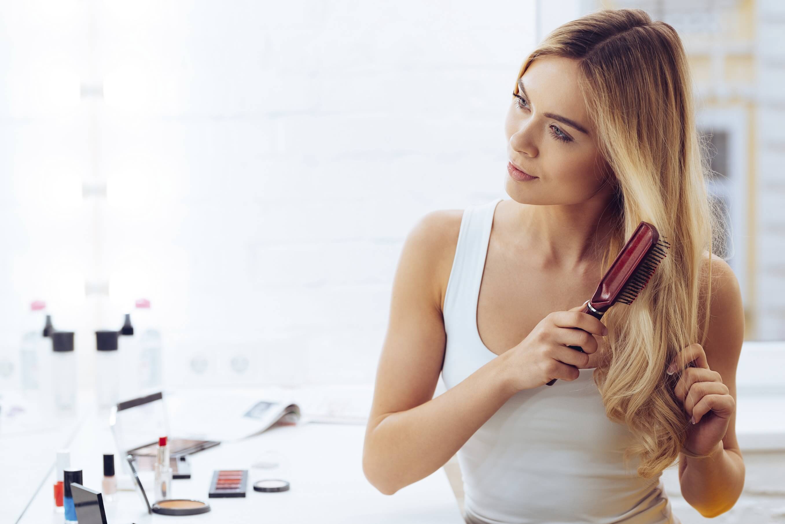 Blonde women brushing her hair