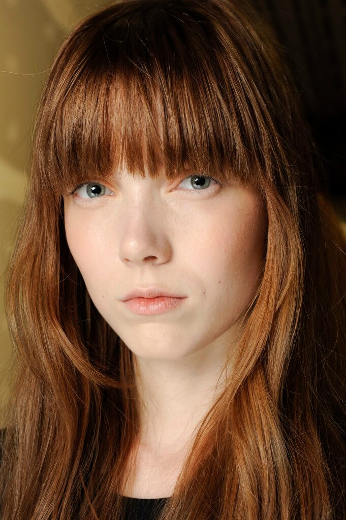 woman with brown hair and a rounded fringe
