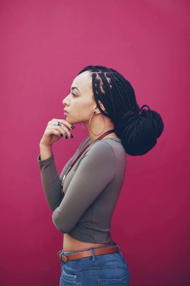 a dreadlock long hair sexy woman on a red background
