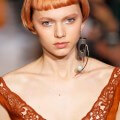 model on the runway with a bob and blunt fringe with an intense rose gold copper hair