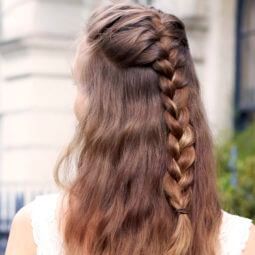 back view of a woman with light brown hair in a half-up french braid