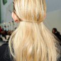 back view of a model with long blonde highlighted hair