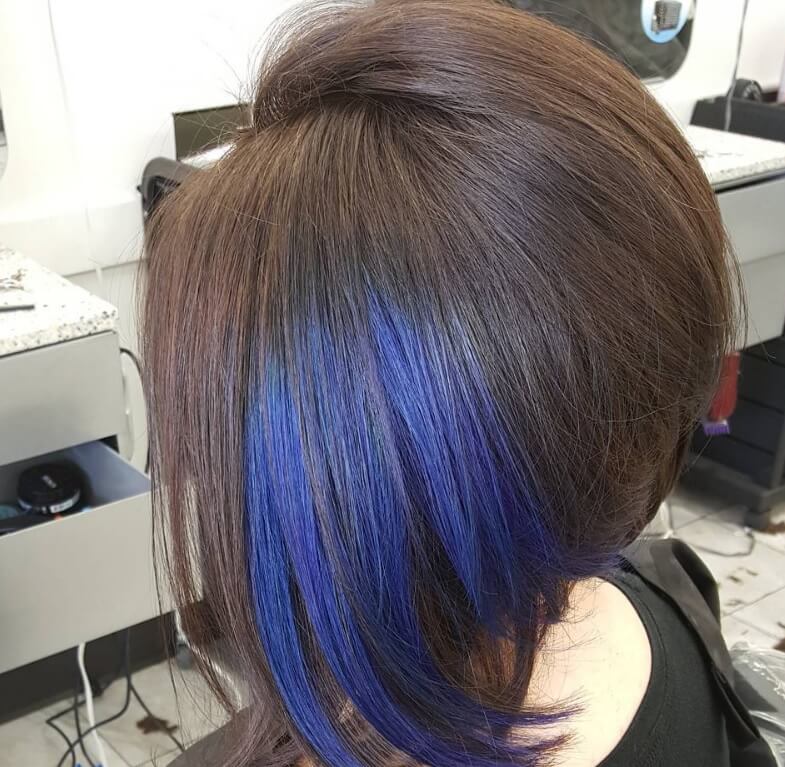 Dark brown inverted bob with a dip dye bright blue streak