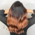woman with naturally dark hair wearing a copper ombre