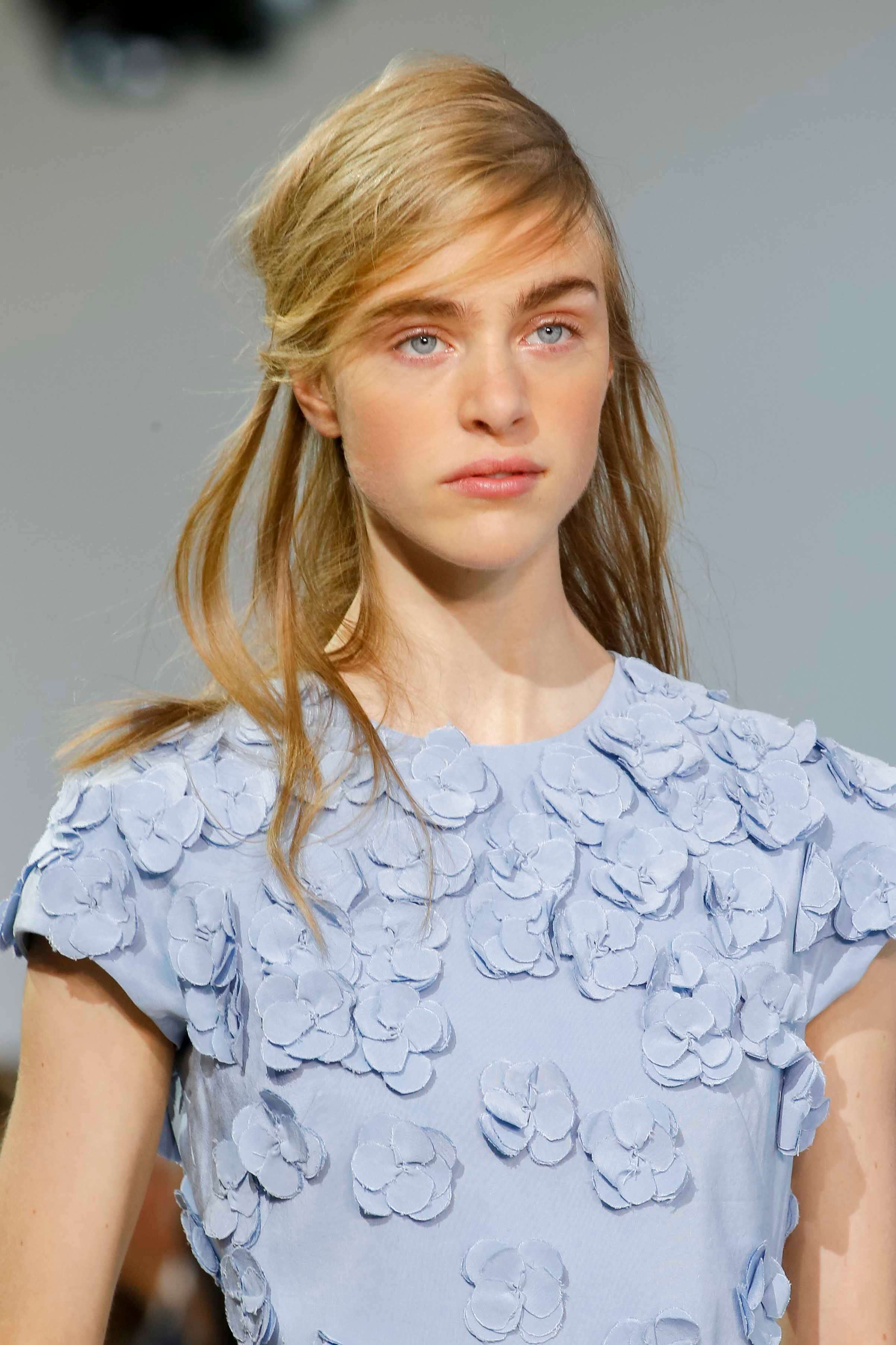 Blonde hair: Image of a model on a catwalk with blonde hair long and worn in half-up, half-down style.