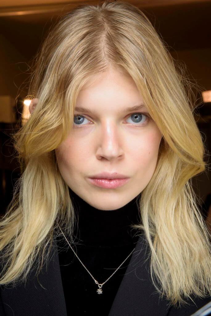 Blonde woman with curtain bangs long hairstyles for round faces