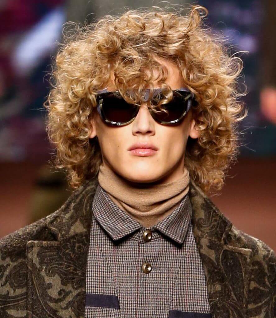 male model with sunglasses and blonde soft body curls