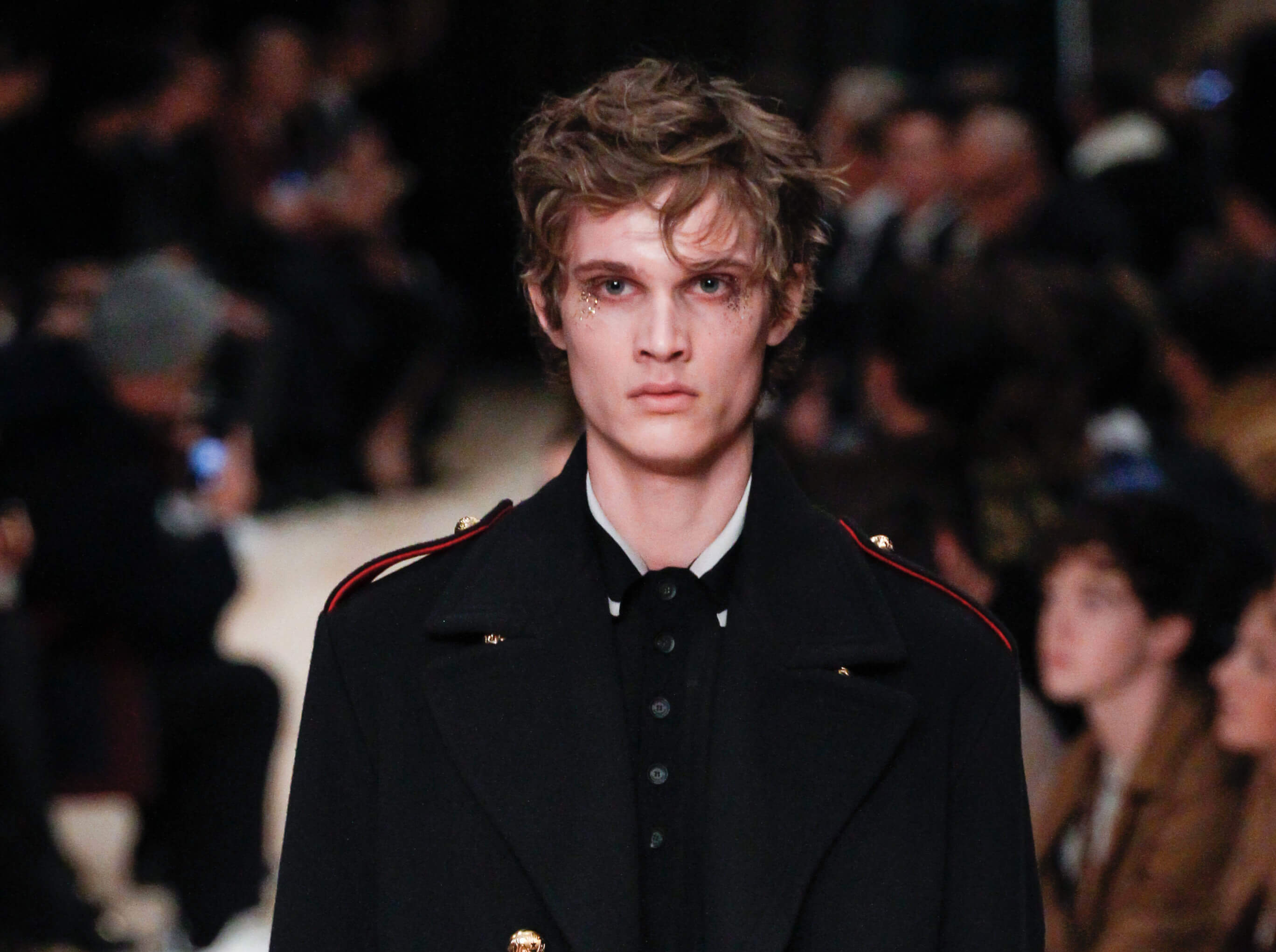 brown haired male runway model at fashion week with messy textured bed hair