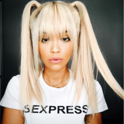 front facing image of Rita Ora with blonde hair in pigtails and a full fringe with platinum blonde hair