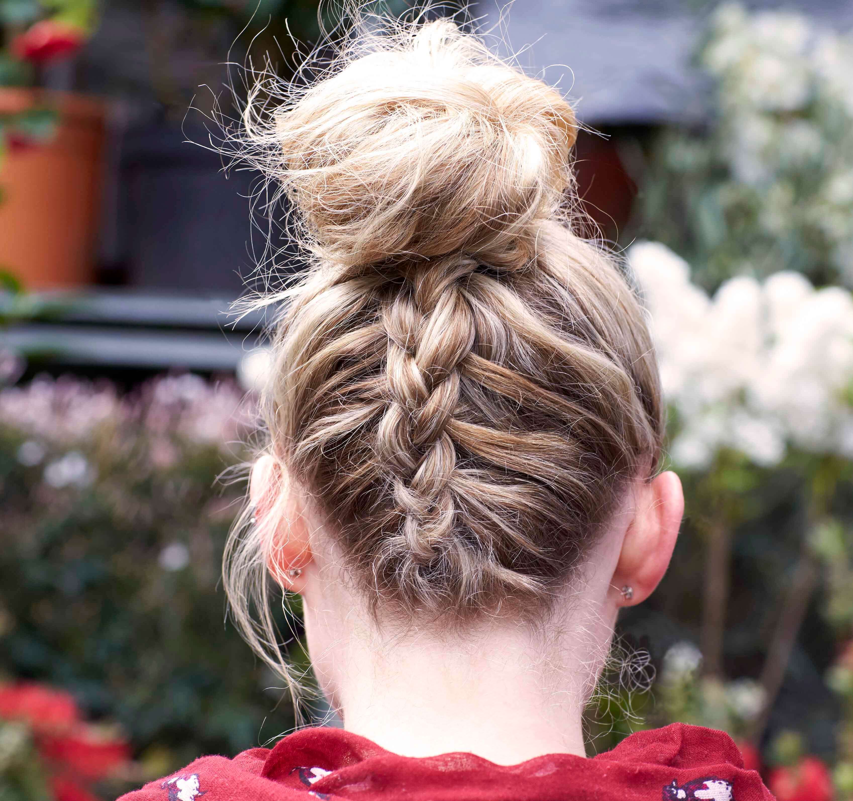 updos for medium hair: A blonde model with an upside down Dutch braid and high bun