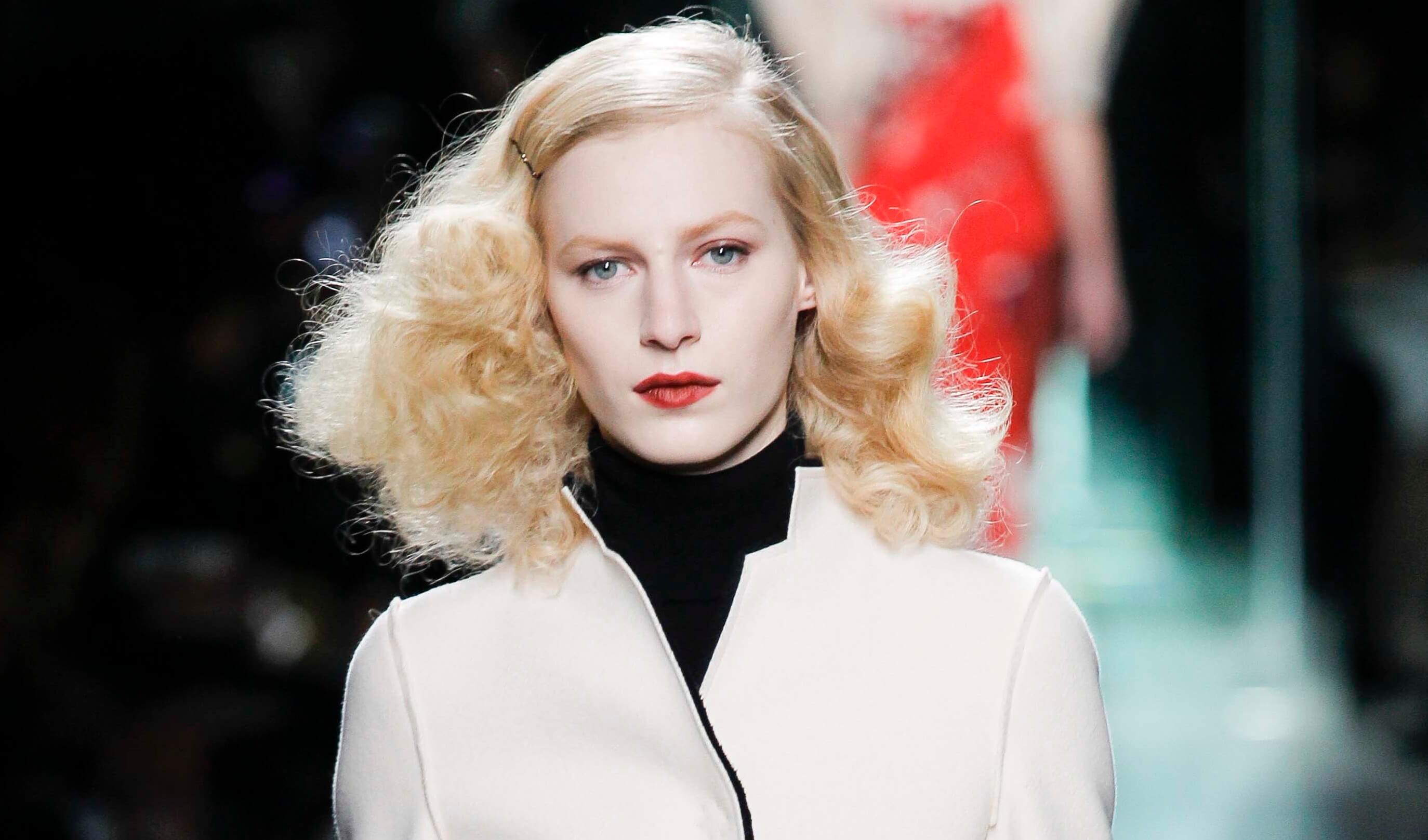Blonde hair: Front facing view of a woman with golden-platinum-blonde hair and red lips.
