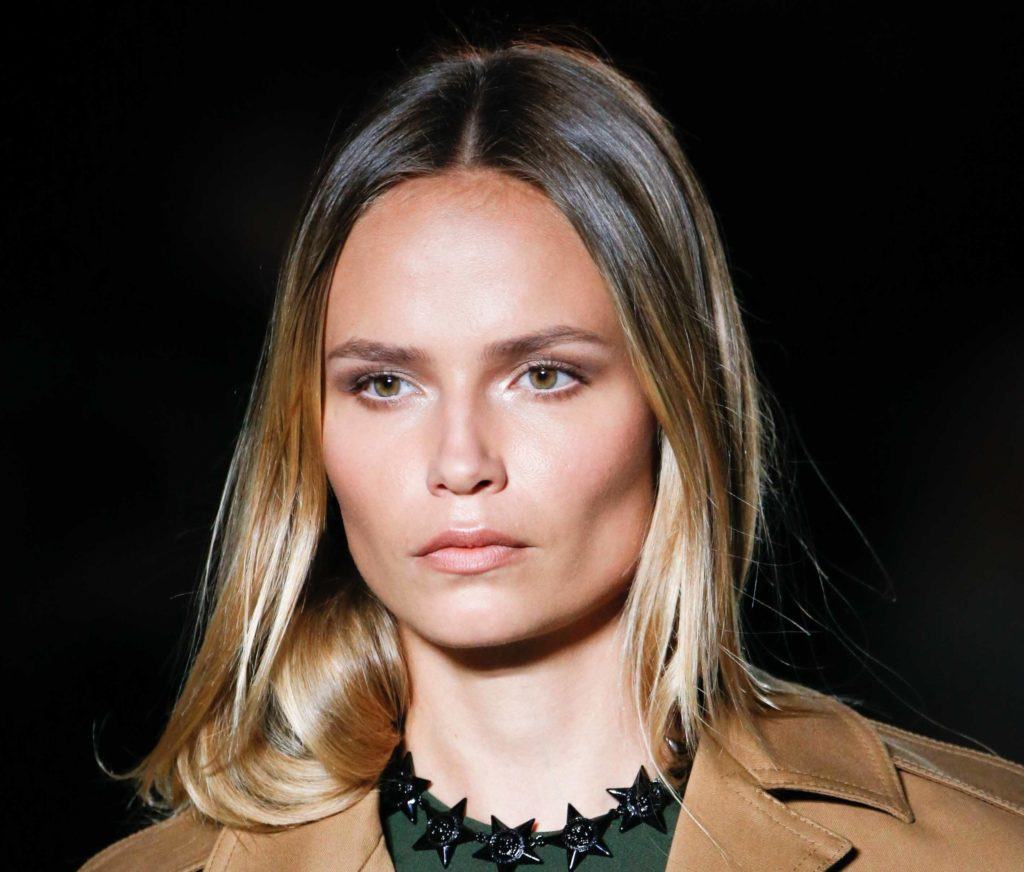 front image of a woman with ombre dark blonde hair worn down