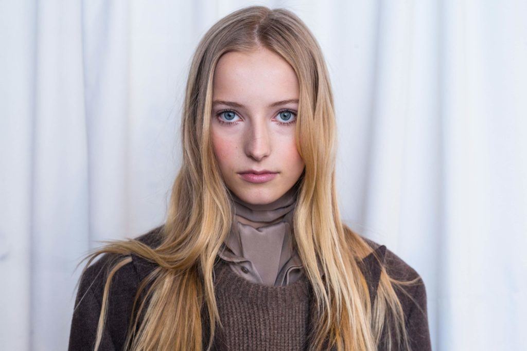 image of a woman with very long dark blonde hair worn down