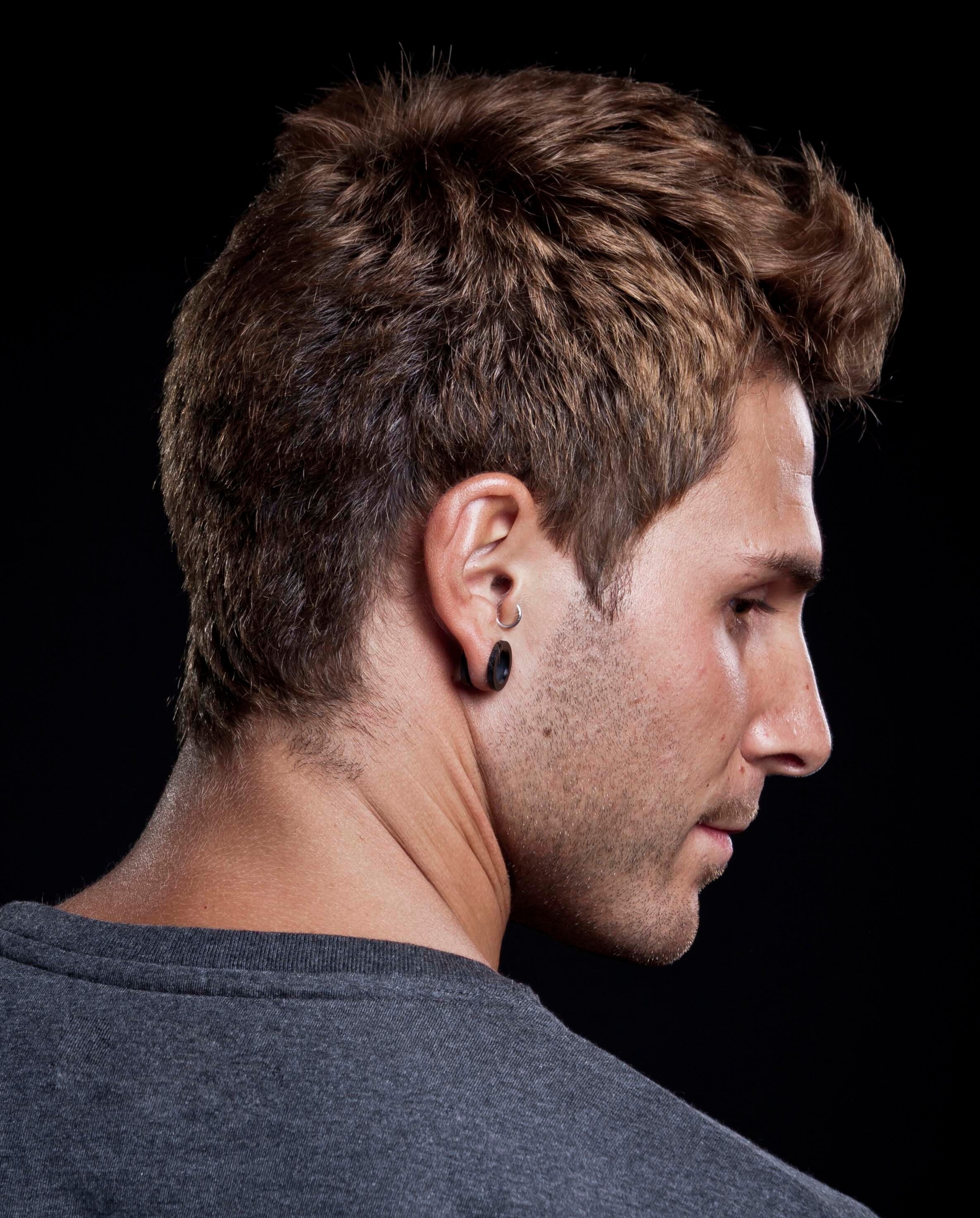 medium brown haired man with a feathered Mohawk