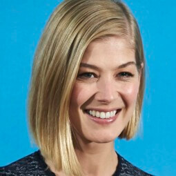 Rosamund Pike with side part golden blonde graduated bob hair