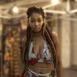 Fake dreadlocks: Black young woman from Afropunk with half-up dreadlock hairstyle