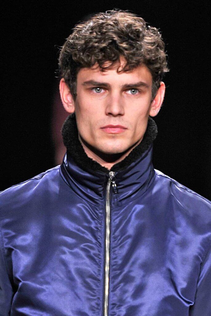 model with dark hair and short controlled curls