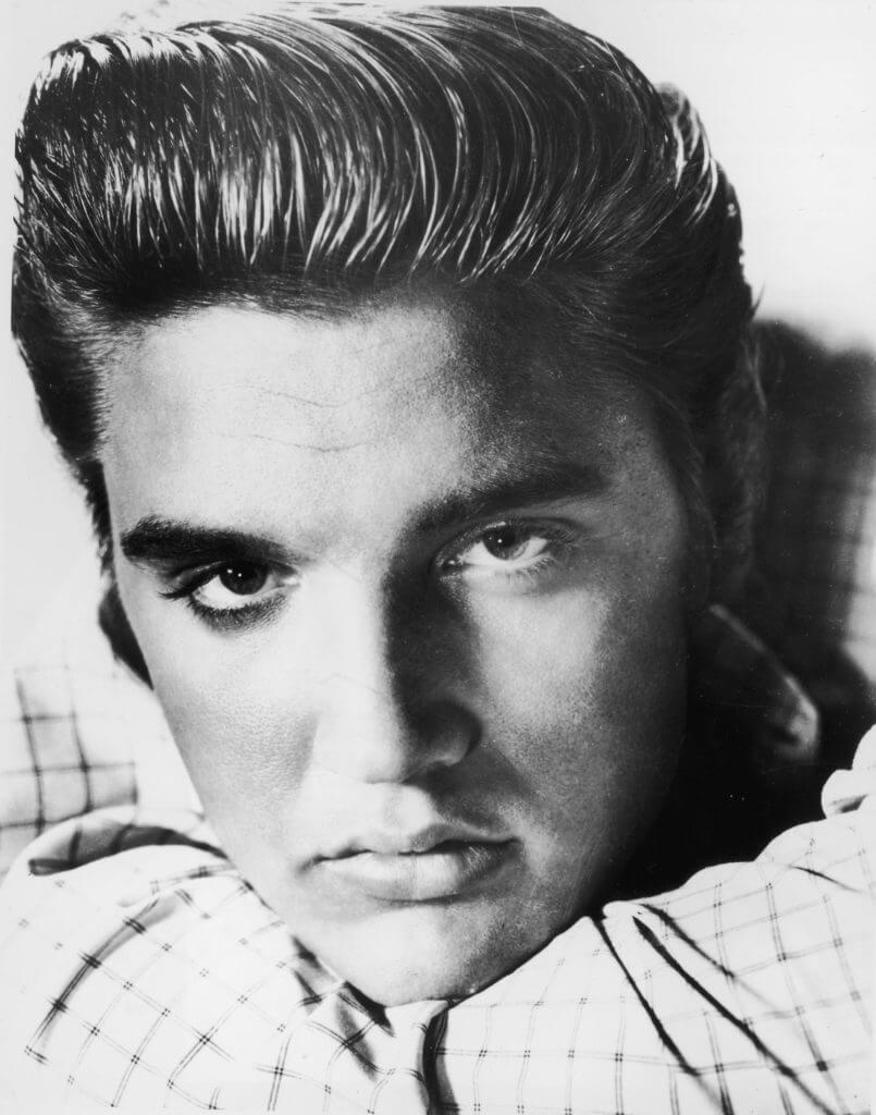 black and white image of Elvis Presley with a big quiff