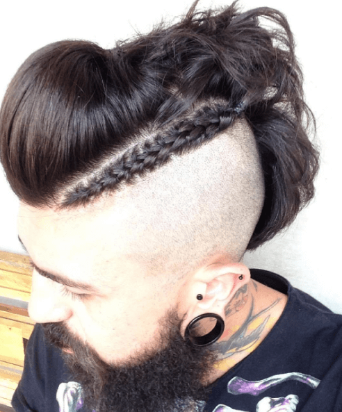 Dark brown haired man with Mohawk and cornrow