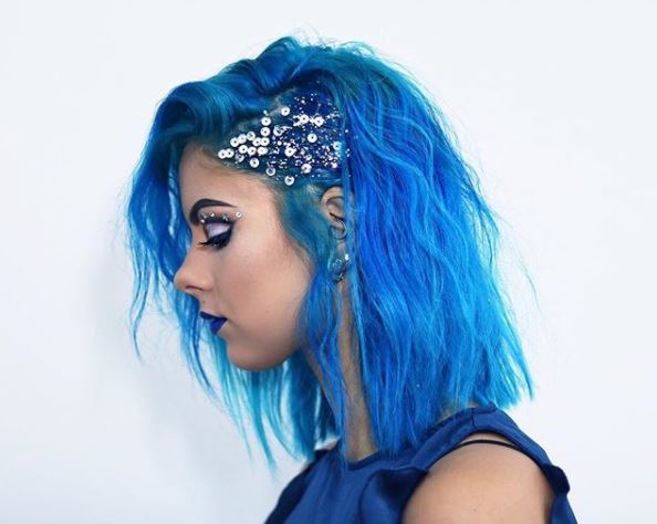 side view of a @sophiehannahrichardson with slicked back hair on one side and glitter