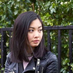 Young Asian woman with a straight bob looking to the side