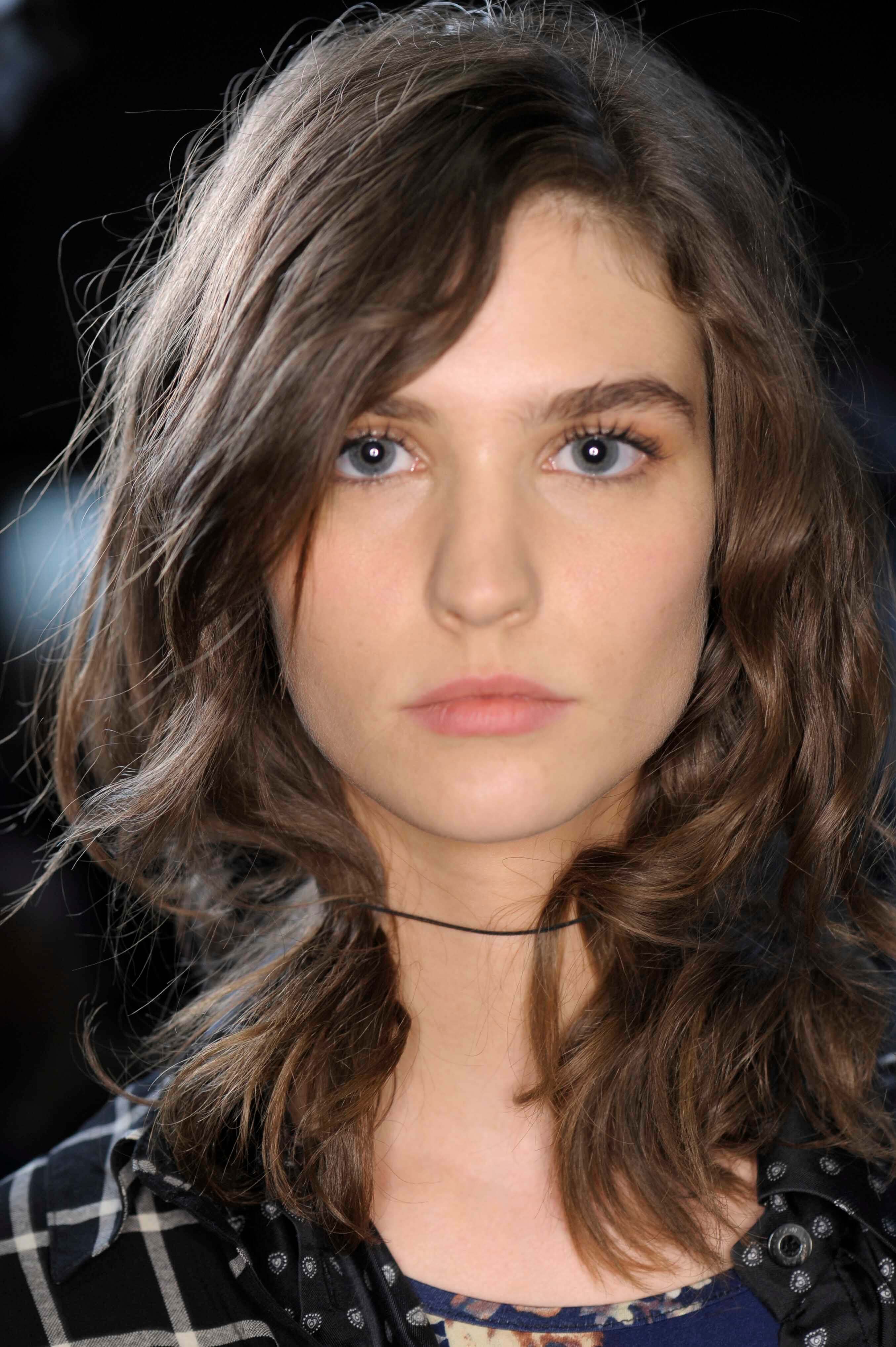 Medium length hairstyles for fine hair: Woman with brown wavy medium length hair.