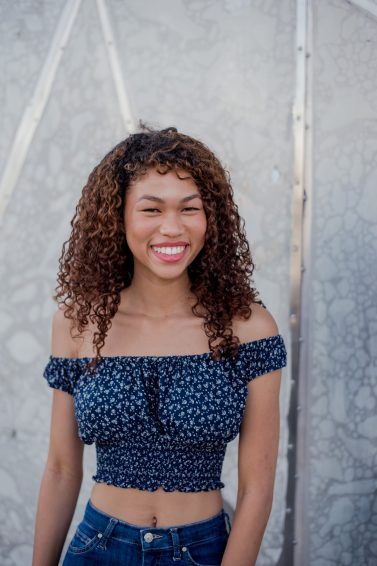 Woman with medium curly hair smiling