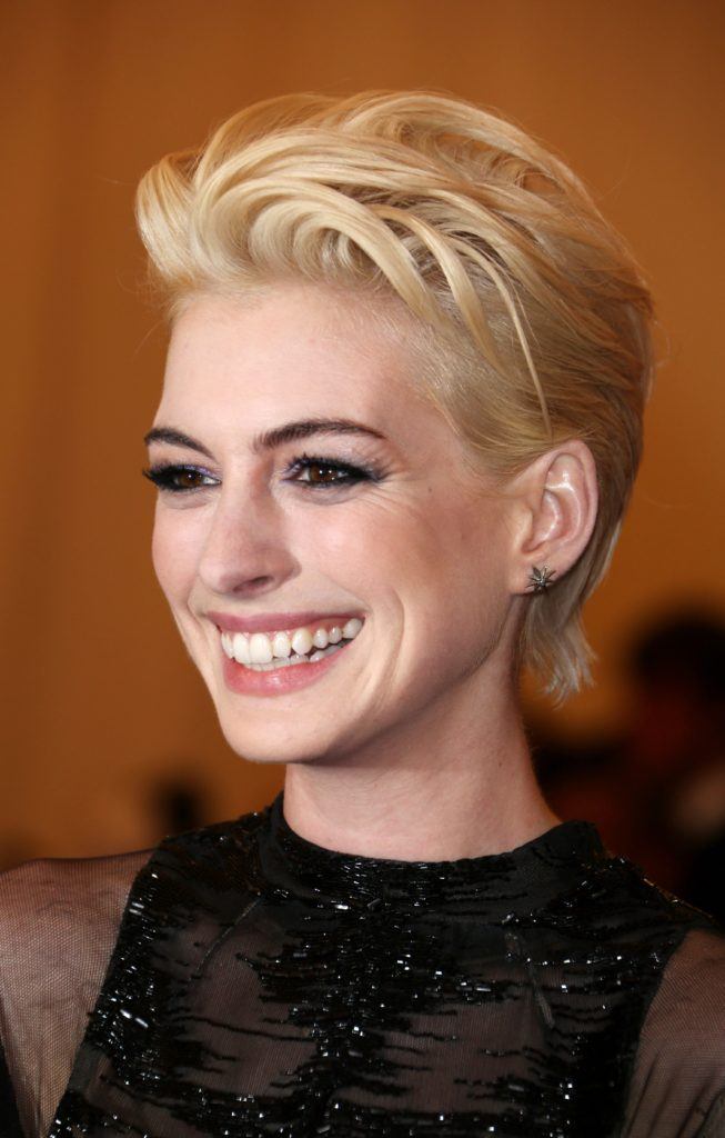 image of Anne Hathaway with bleached hair in a pixie cut and glamorous makeup