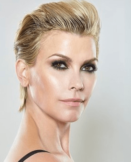 front facing image of a woman with a blonde haired pixie cut