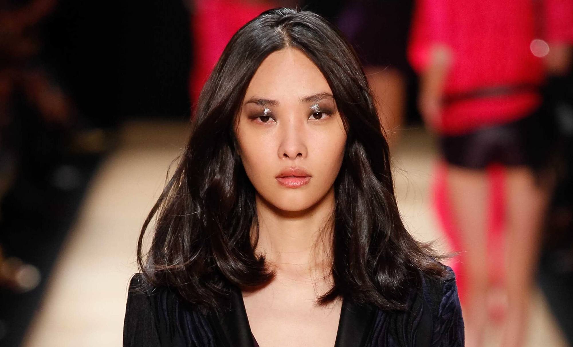 Haircuts for thick hair: Asian model on the runway with shoulder length dark layered hair