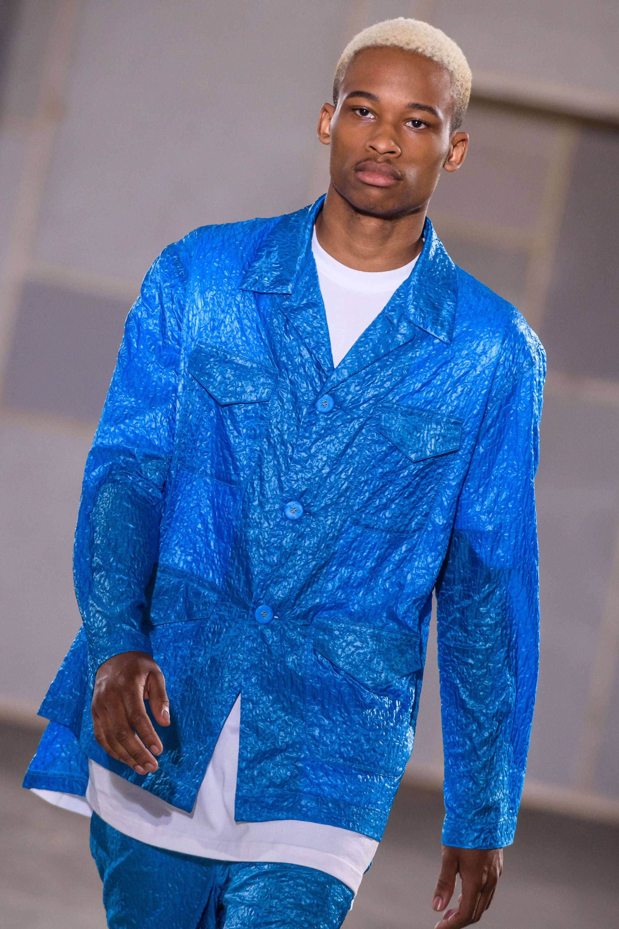 close up shot of black man with blonde high and tight, with subtle low fade, wearing blue on the juilen david runway ss18