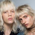 short sexy hairstyles: two platinum blonde models rock short sexy hair with bangs