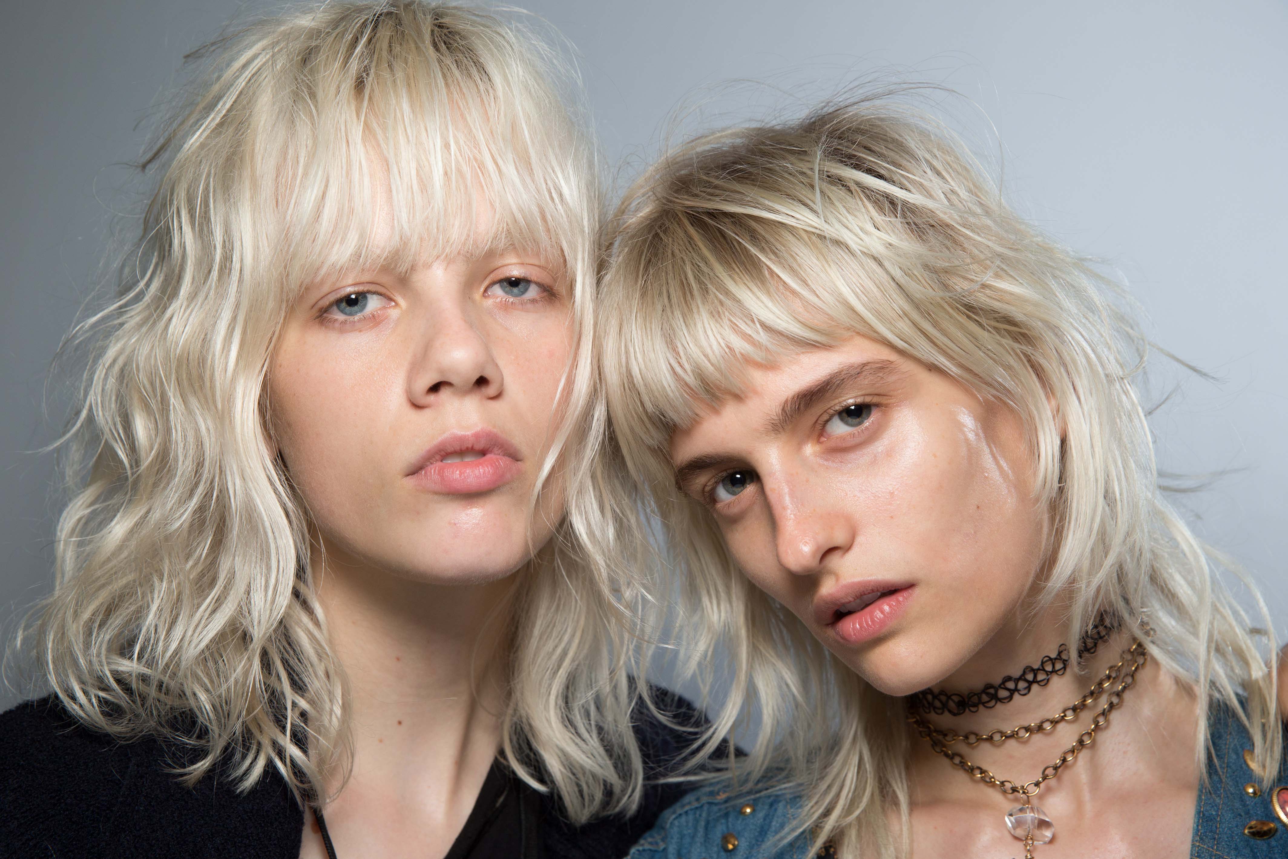 short sexy hairstyles: two platinum blonde models rock short sexy hair with bangs