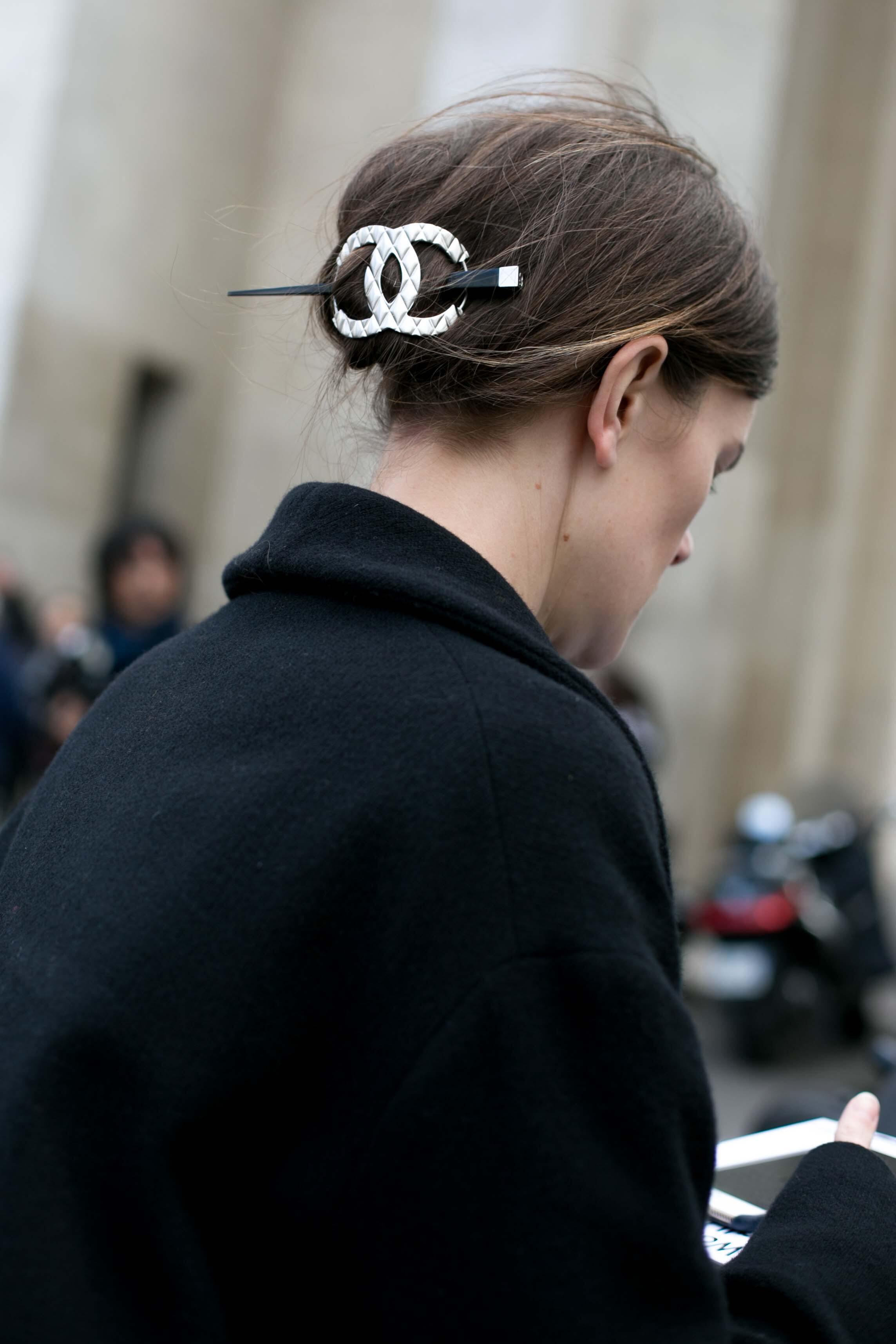 back view of woman with a large chanel hair accessory