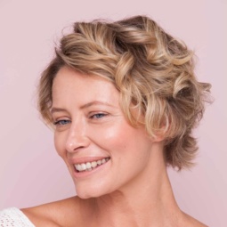 Older blonde woman with beach waves and short hair
