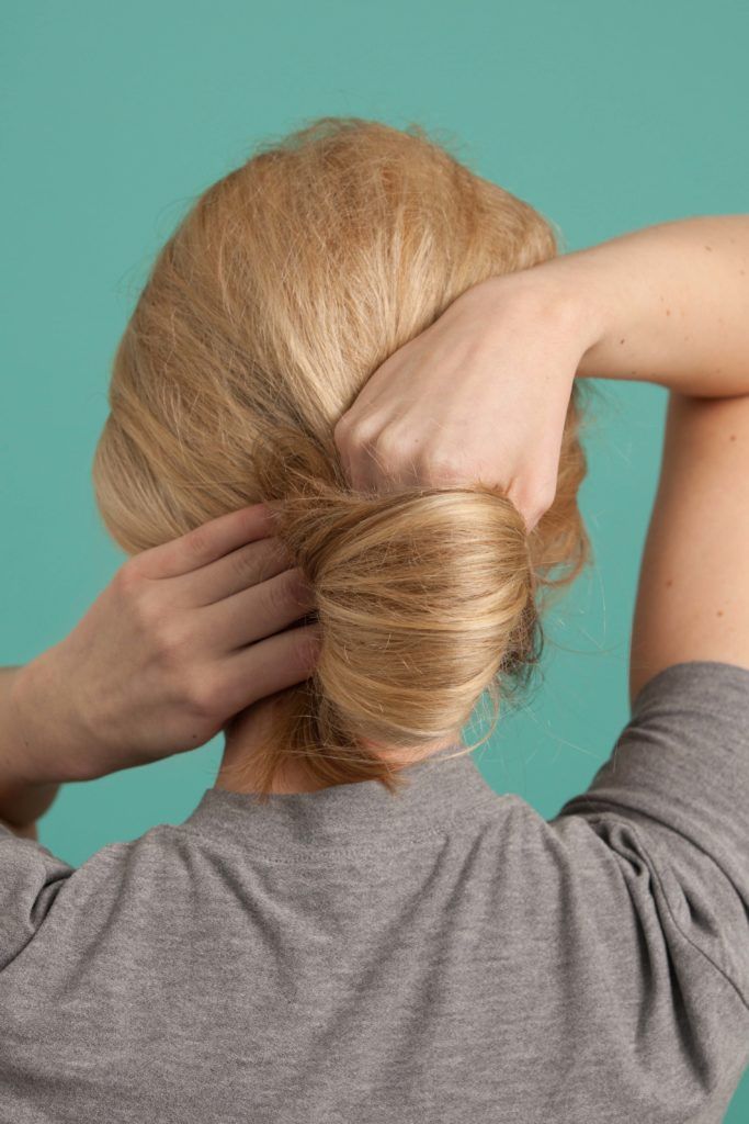 a blonde woman making a frech twist