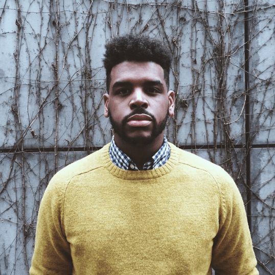 front facing image of a black man with a high top fade - black men hairstyles