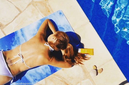 girl lying down with blonde beach hair ponytail