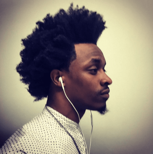 side view of a black man with afro hair and a goatee - black men's hairstyles