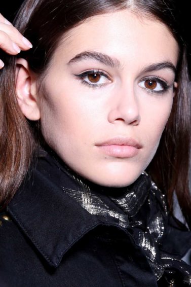 Kaia Gerber backstage image medium length brown straight hair been styled