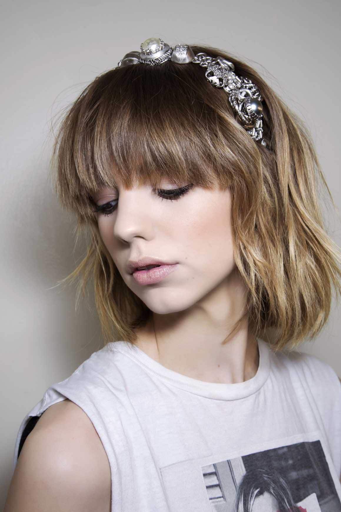Blonde hair: Side view of a woman's face with a fringe and bobbed hair with a blonde ombre colour