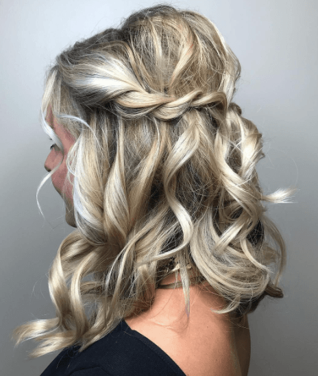 side view image of a womans hair with a braid and worn long and wavy - golden blonde hair