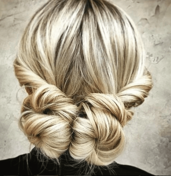 back view of a woman's hair with low space buns - golden hair