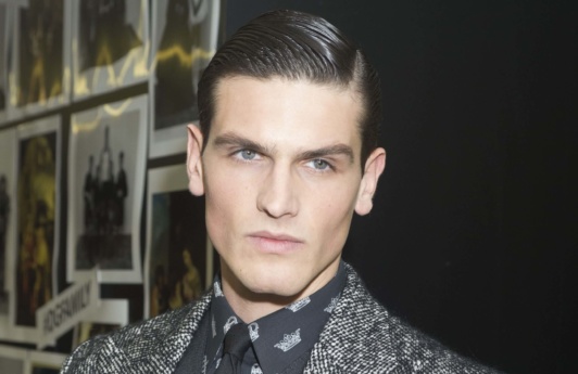 Dark haired man with groomed side parting hairstyle