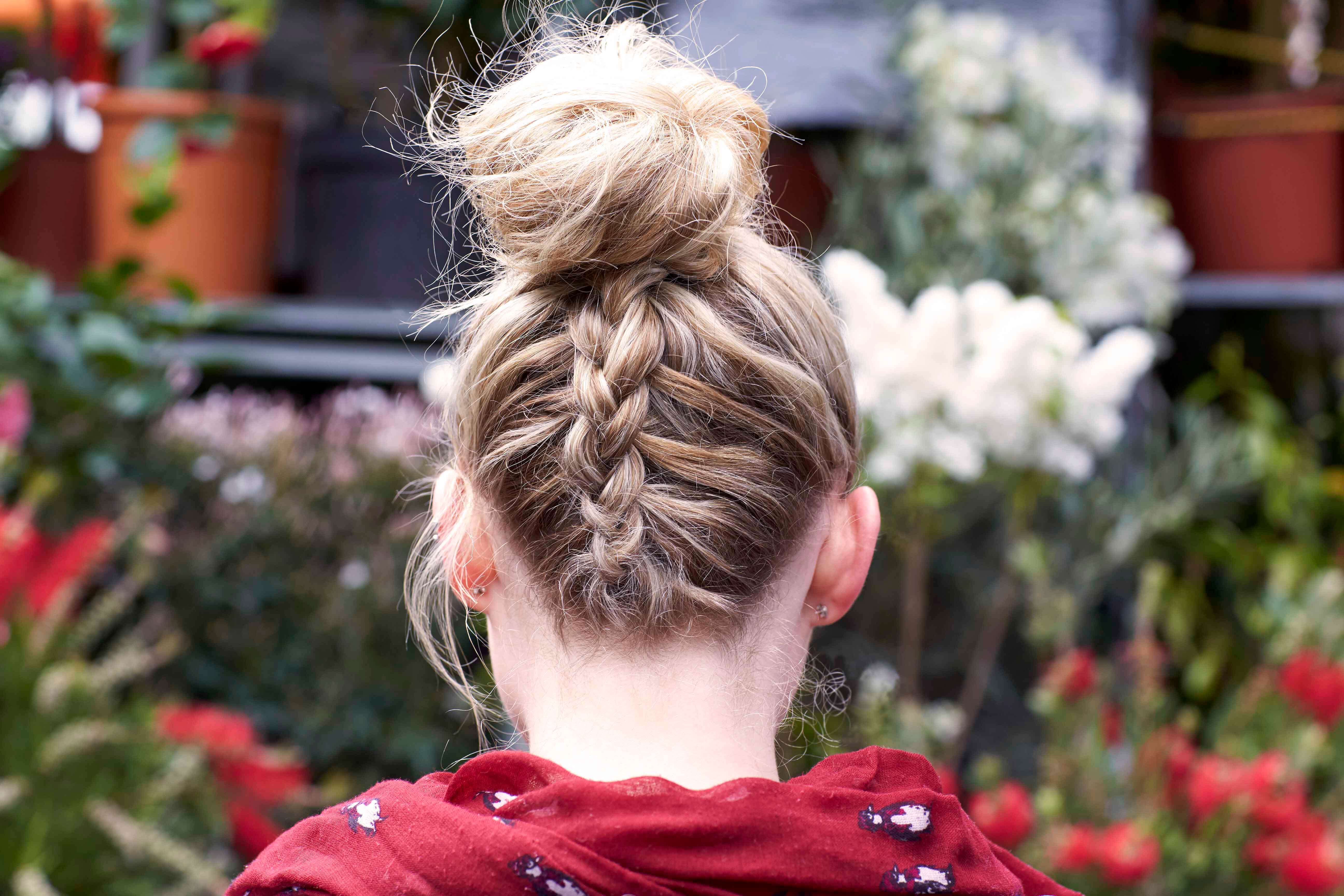 back view of model with blonde bun with French braided back