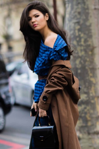 Long-haired brunette with blowout hair at Fashion week street style