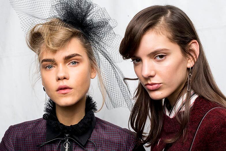models from the Isabel Marant aw16 show with the left model wearing a black hairnet in her blonde hair and the right model with her brown worn down in waves